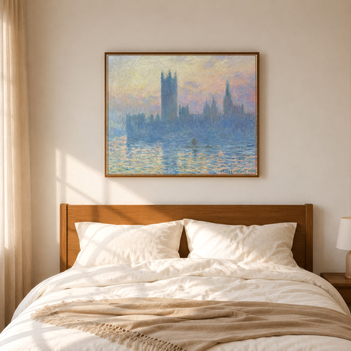Framed art print of Houses of Parliament at Sunset by Claude Monet, in a slim wood frame above a bed in a sunlit bedroom