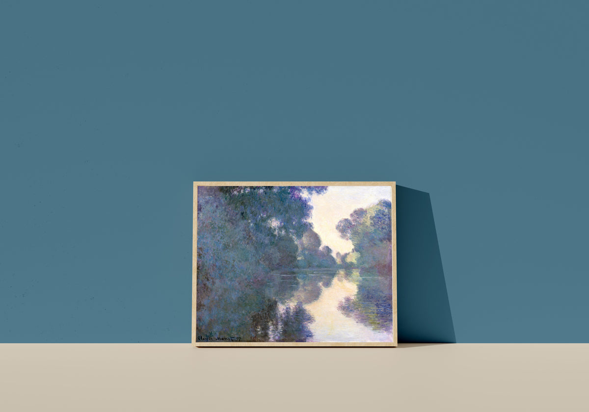 Framed art print of Morning on the Seine near Giverny by Claude Monet, in a light wood frame leaning on a blue wall