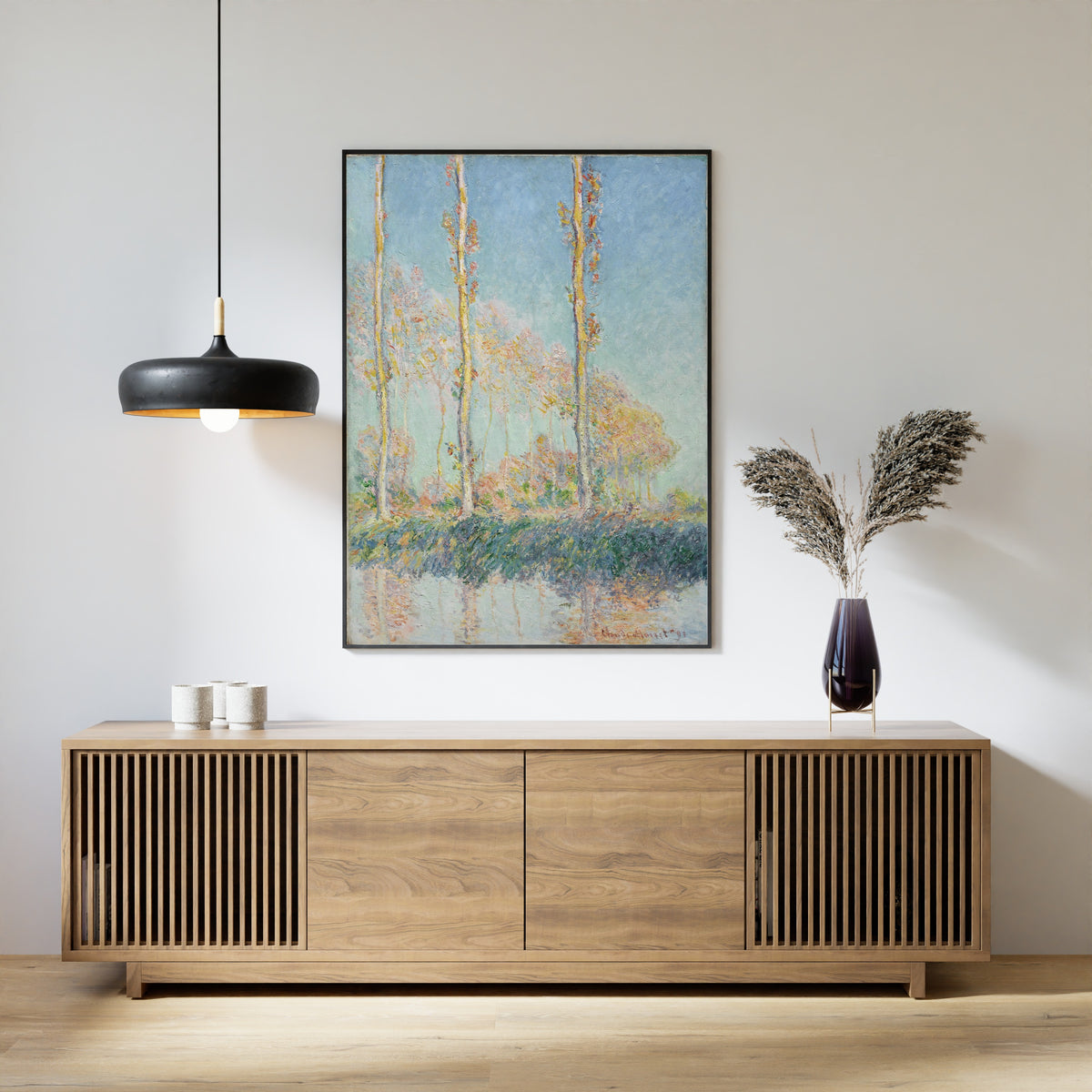 Poplars (Four Trees) by Claude Monet — framed above a slatted wood sideboard