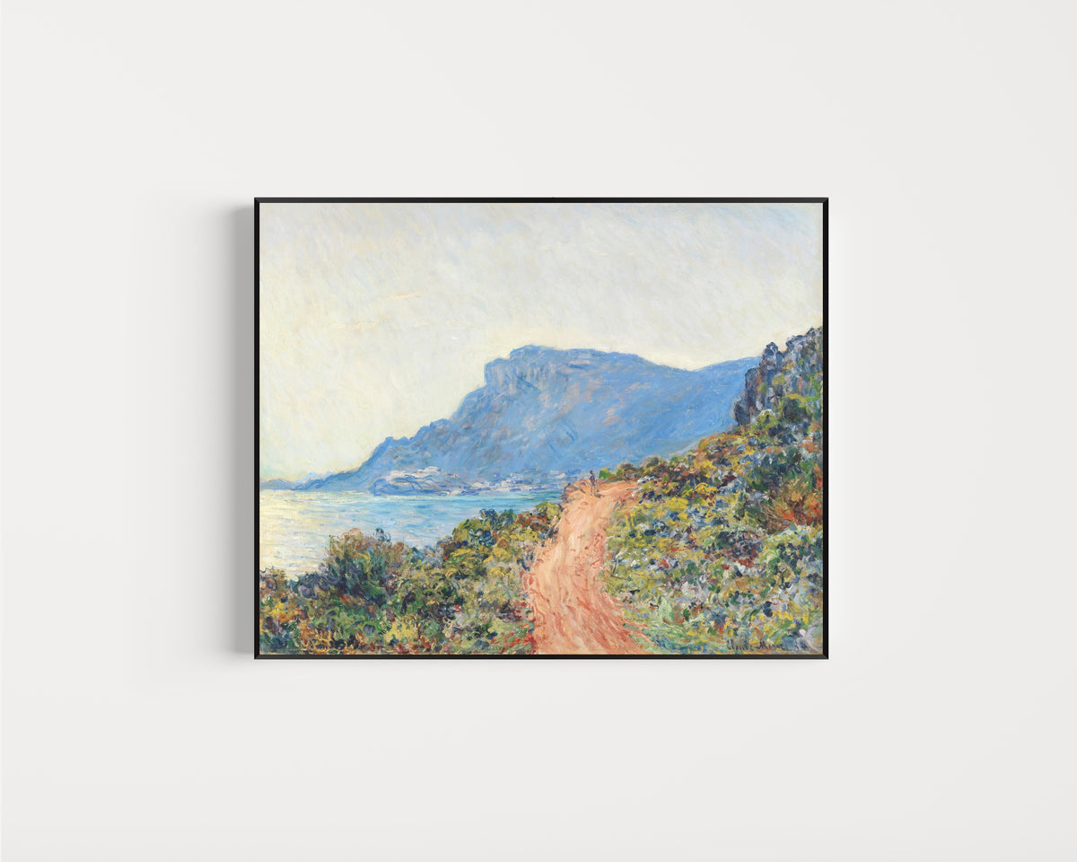 Framed art print of The Corniche near Monaco by Claude Monet, in a slim black frame on a plain white wall