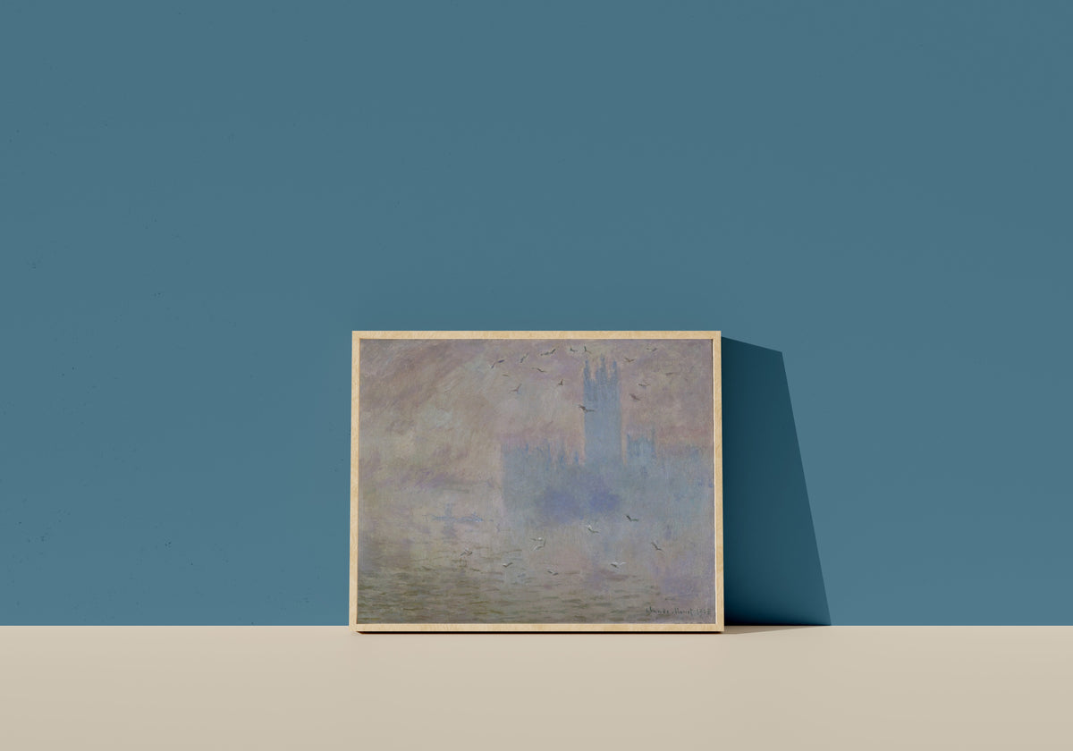 Framed art print of The Houses of Parliament, Seagulls by Claude Monet, in a light wood frame leaning on a blue wall