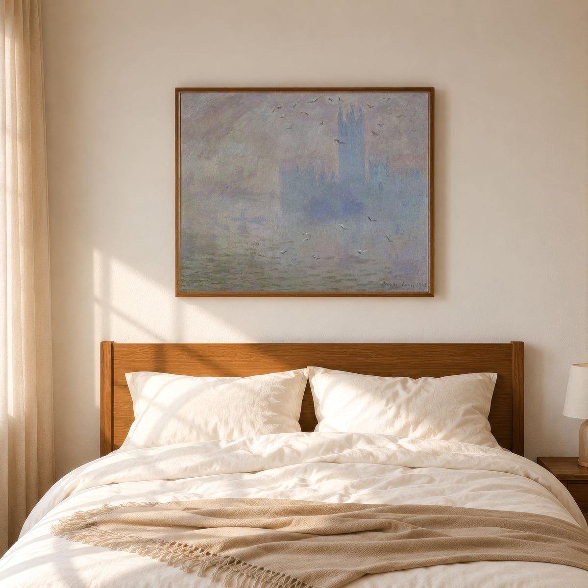 Framed art print of The Houses of Parliament, Seagulls by Claude Monet, in a slim wood frame above a bed in a sunlit bedroom