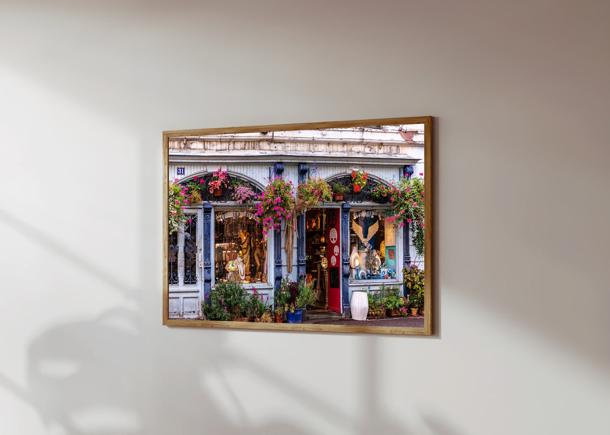 Framed art print of Colmar (Alsace) by Daniela Faust, in a light wood frame on a sunlit white wall, seen at a slight angle