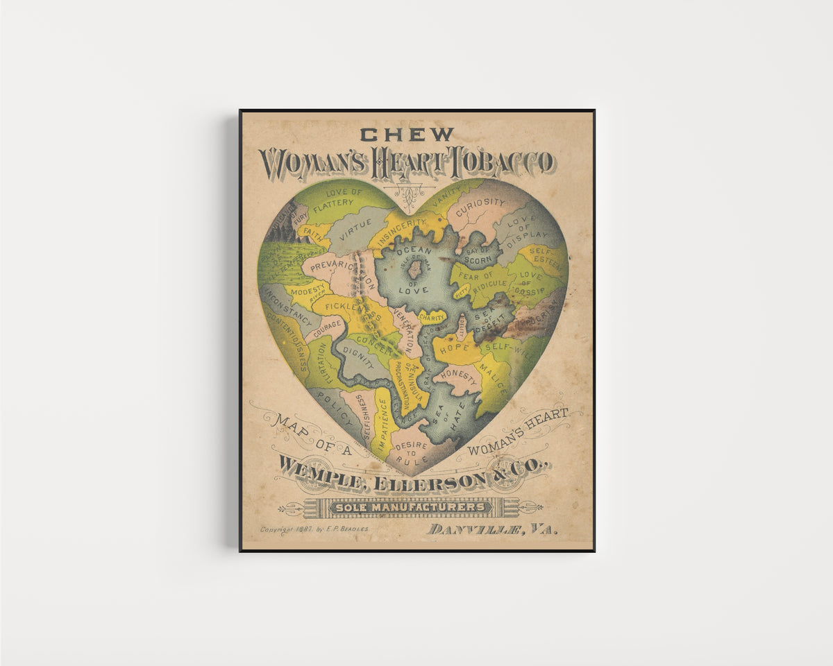 Framed art print of Map of a Woman's Heart by E.P. Beadles, in a slim black frame on a plain white wall