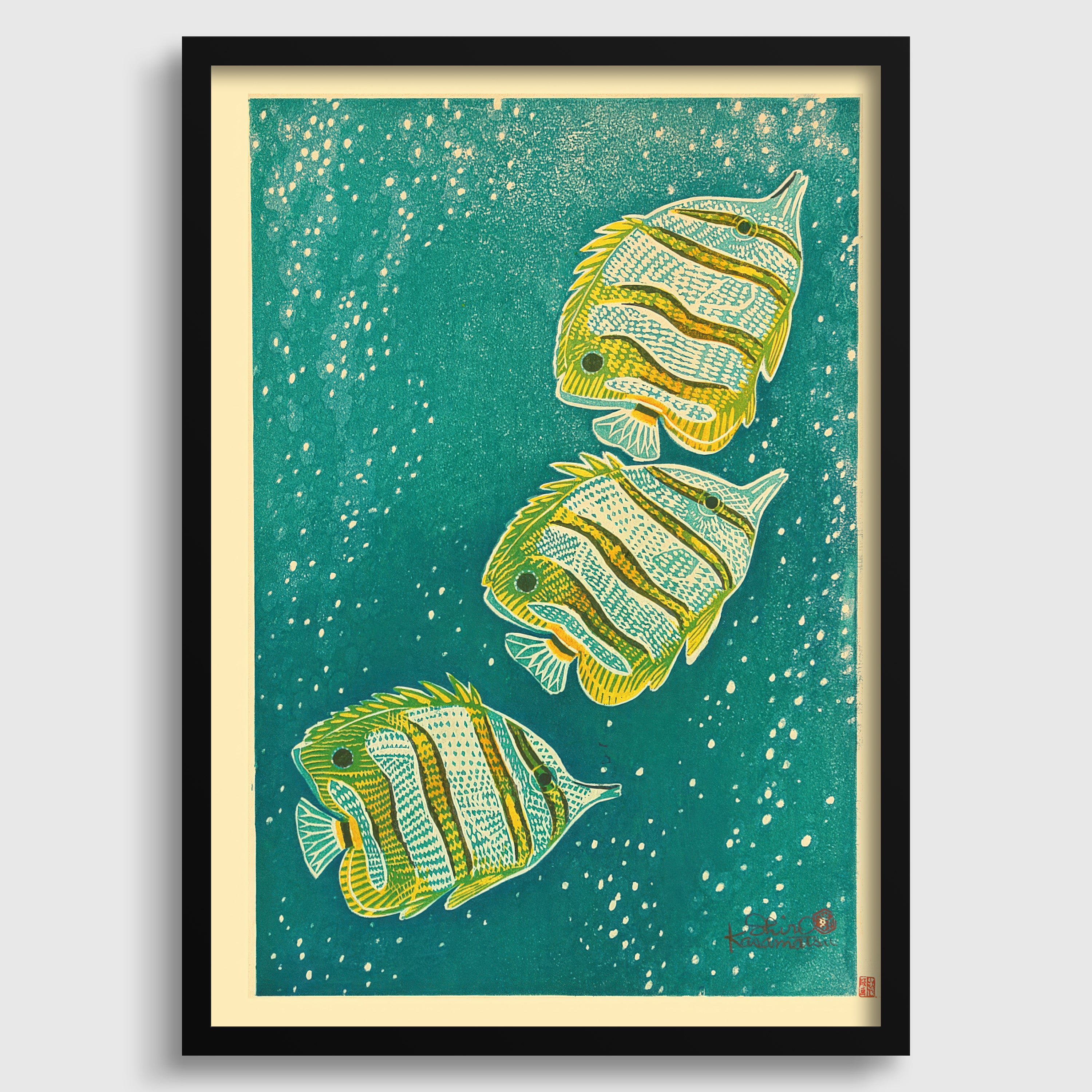 A framed print depicting three colorful fish swimming in a green underwater environment with white speckles.