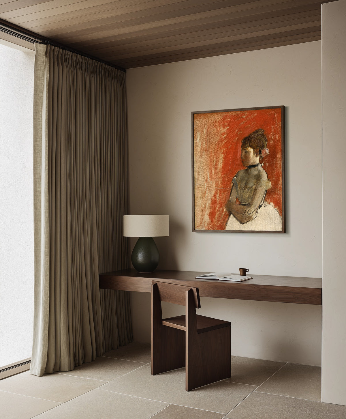 Framed art print of Ballet Dancer with Arms Crossed by Edgar Degas, in a dark wood frame on a plaster wall above a walnut desk