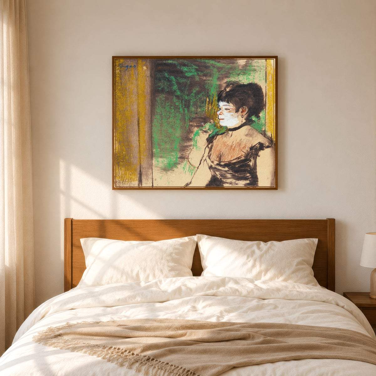 Framed art print of Chanteuse de café-concert by Edgar Degas, in a slim wood frame above a bed in a sunlit bedroom