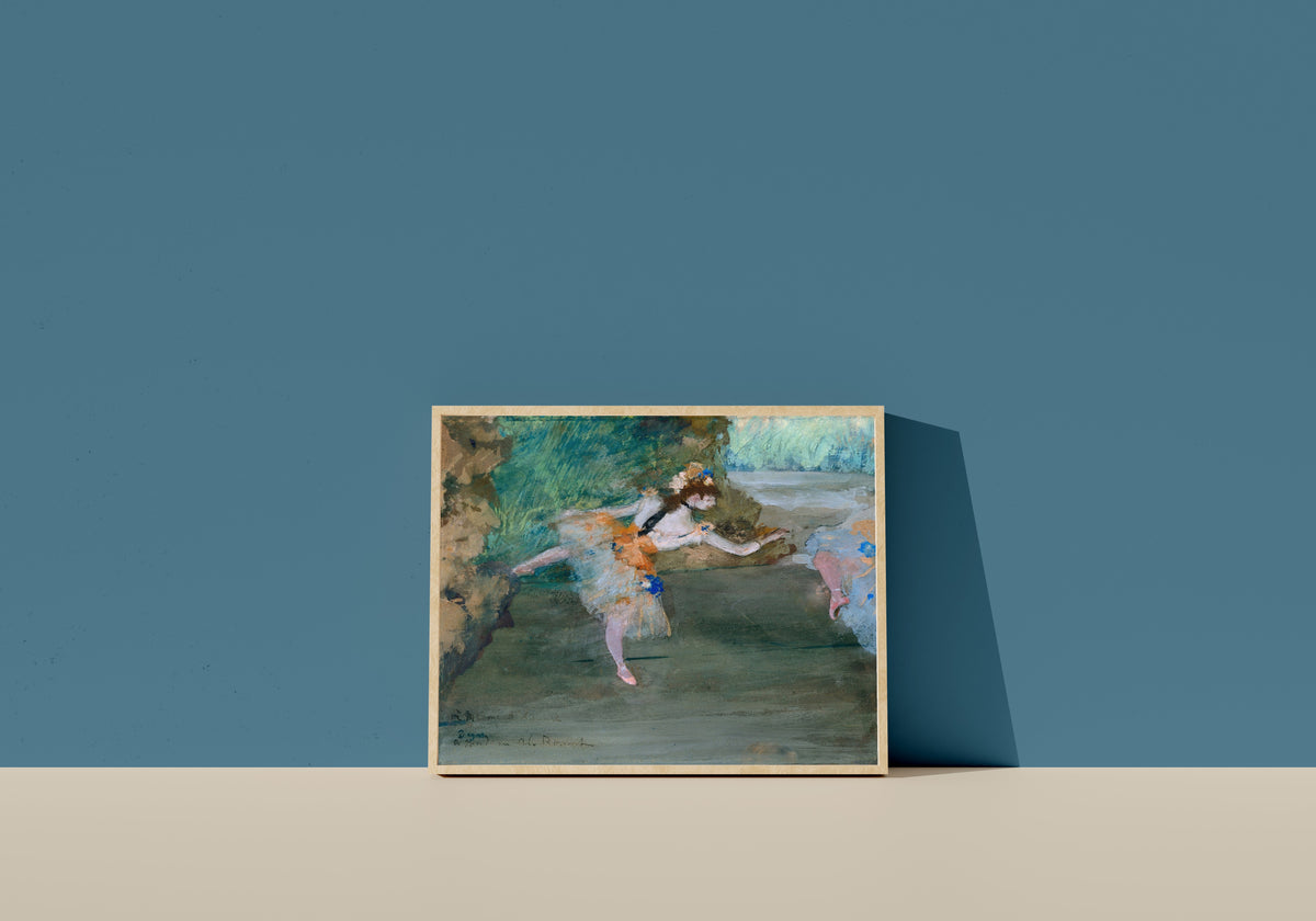 Framed art print of Dancer Onstage by Edgar Degas, in a light wood frame leaning on a blue wall