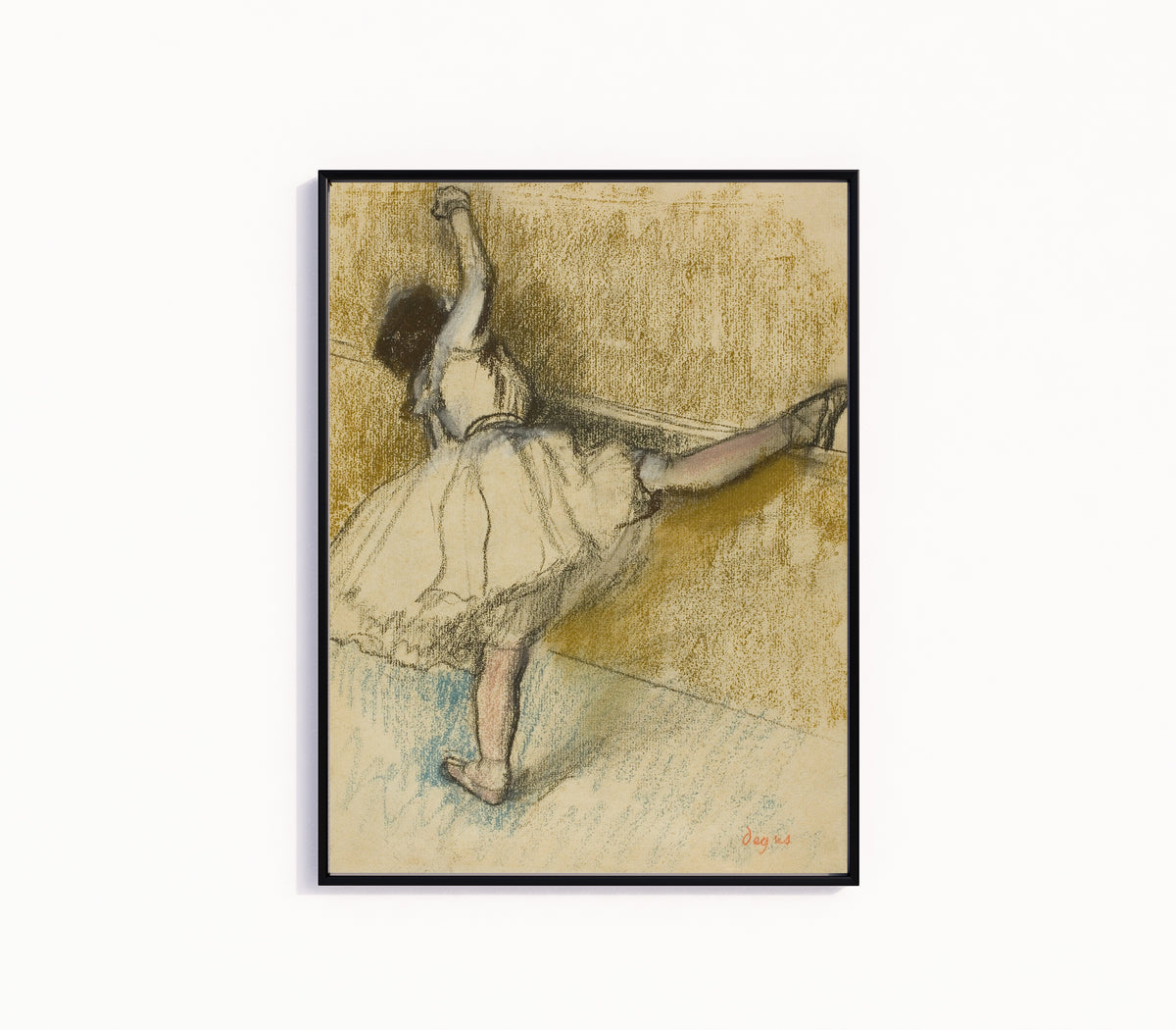 Framed art print of Dancer Stretching at the Bar by Edgar Degas, in a slim black frame on a plain white wall