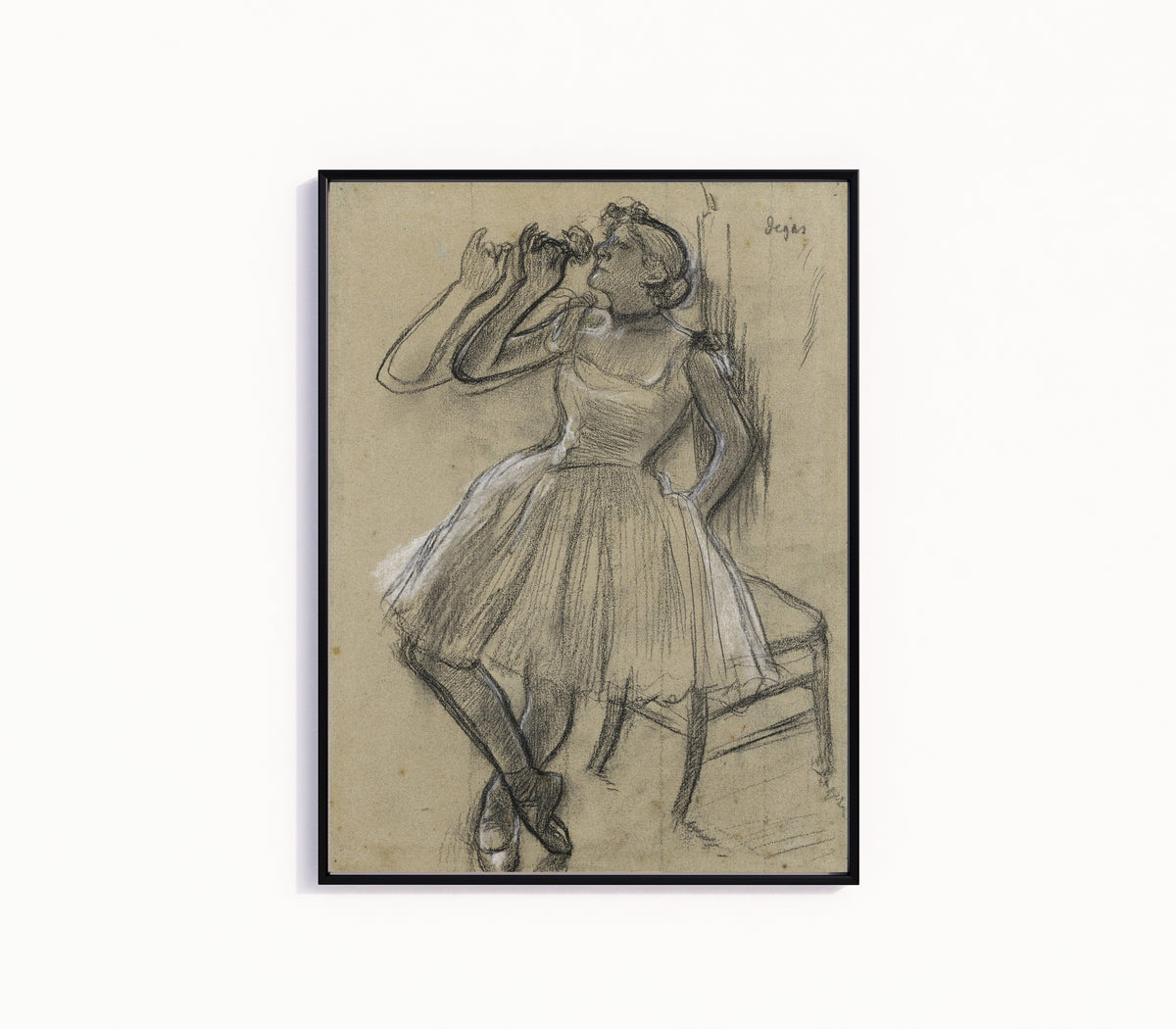 Framed art print of Danseuse à la rose by Edgar Degas, in a slim black frame on a plain white wall