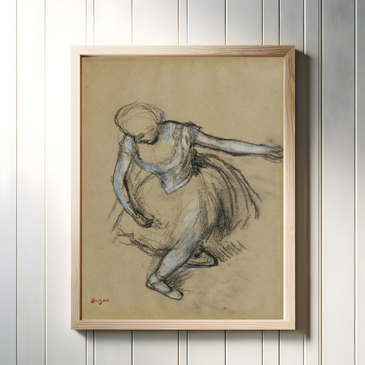 Framed art print of Danseuse saluant by Edgar Degas, in a light wood frame on a white panelled wall