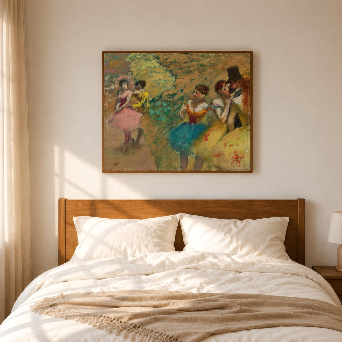 Framed art print of Danseuses (Les Coulisses de l’Opéra) by Edgar Degas, in a slim wood frame above a bed in a sunlit bedroom