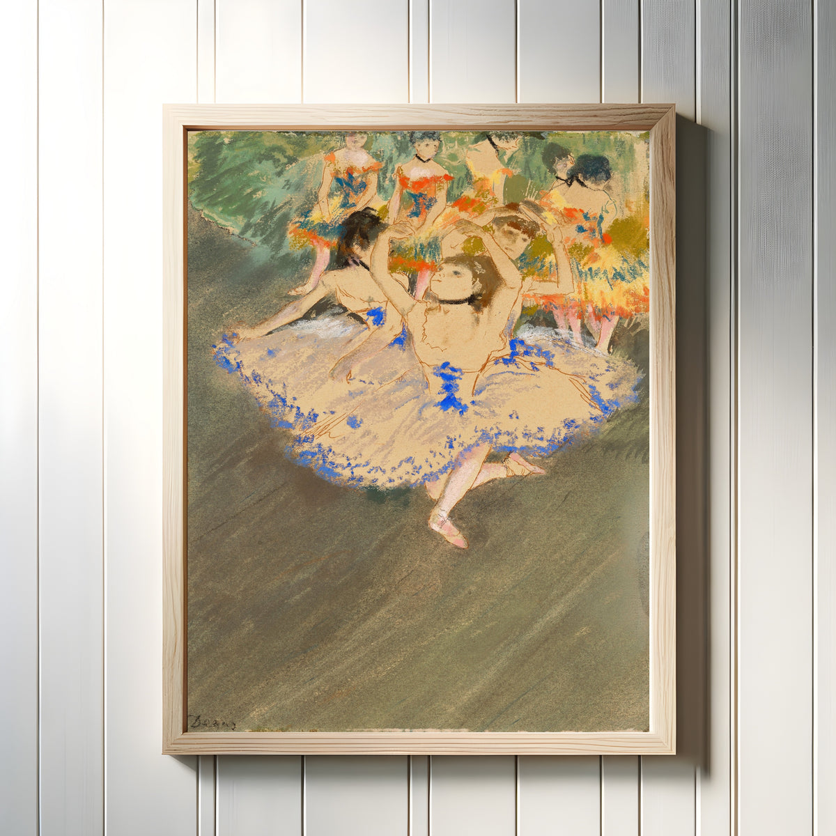 Framed art print of Danseuses sur la scène by Edgar Degas, in a light wood frame on a white panelled wall