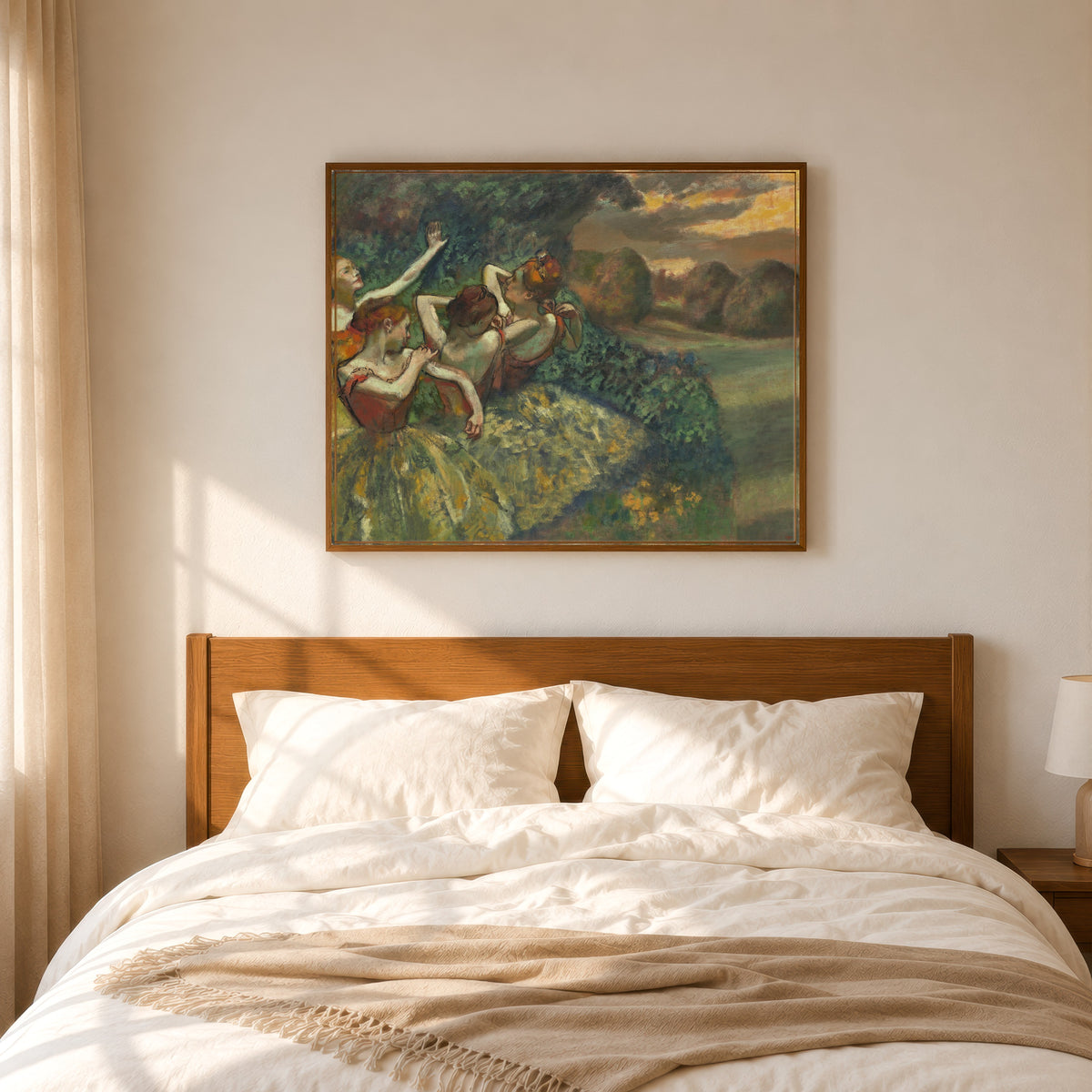 Framed art print of Four Dancers by Edgar Degas, in a slim wood frame above a bed in a sunlit bedroom