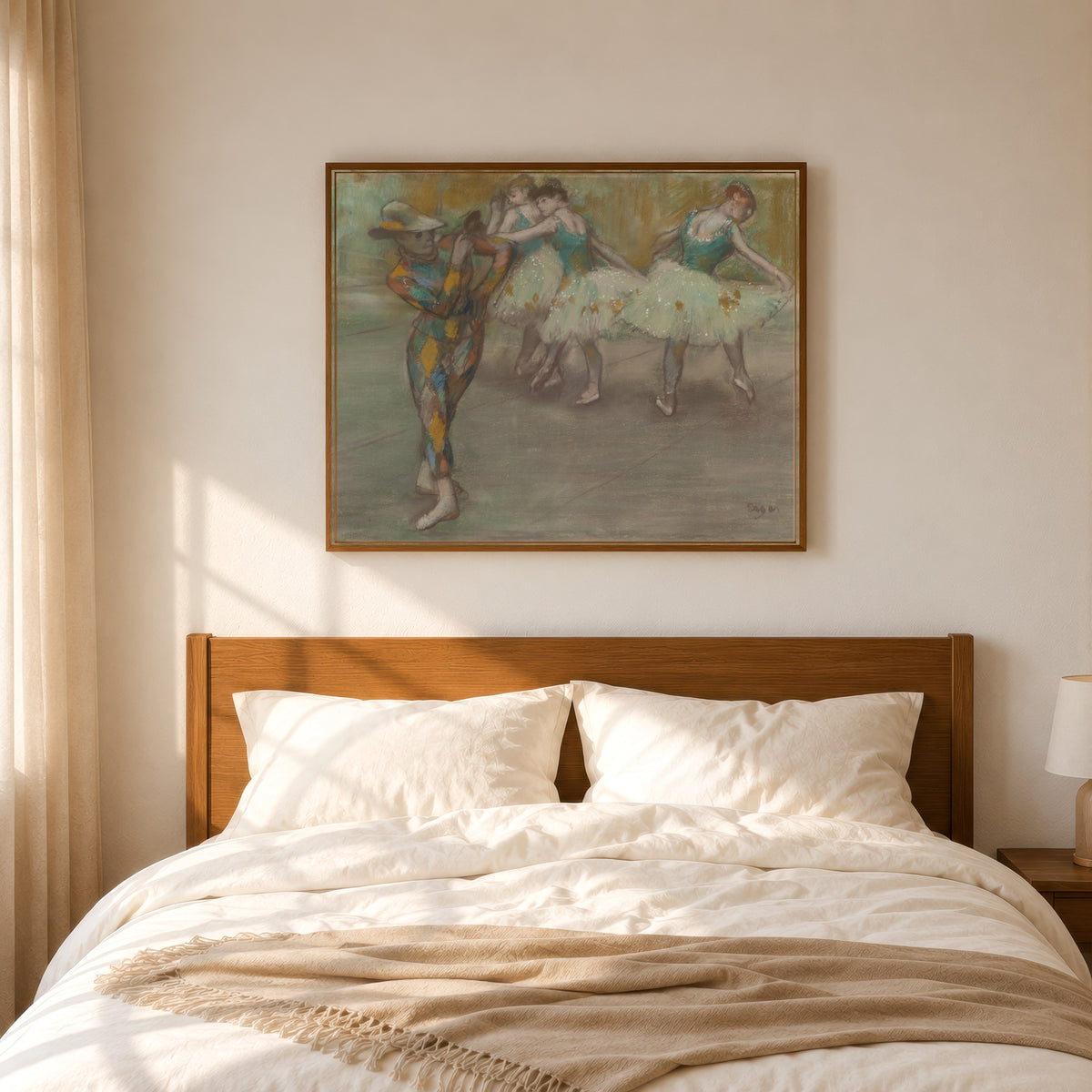 Framed art print of Harlequin Dance by Edgar Degas, in a slim wood frame above a bed in a sunlit bedroom