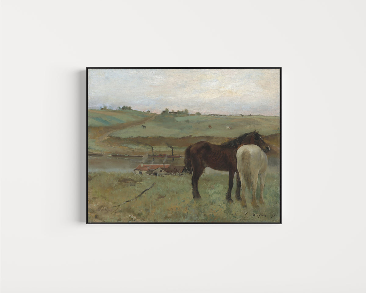 Framed art print of Horses in a Meadow by Edgar Degas, in a slim black frame on a plain white wall