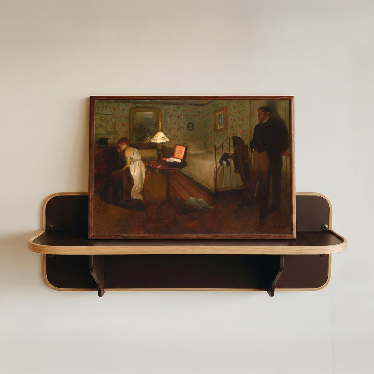 Framed art print of Interior by Edgar Degas, in a dark wood frame resting on a wall shelf