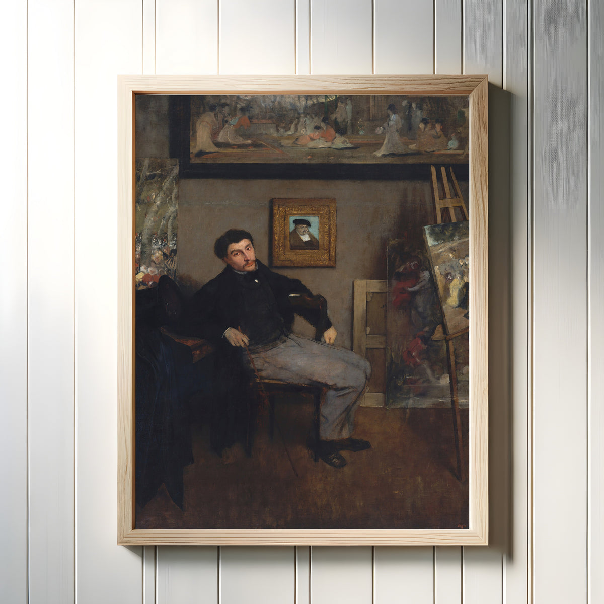 Framed art print of James-Jacques-Joseph Tissot by Edgar Degas, in a light wood frame on a white panelled wall
