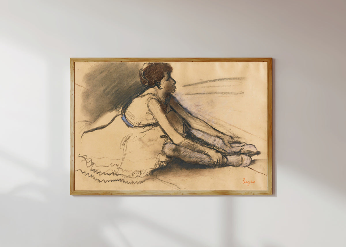 Framed art print of Le repos de la danseuse by Edgar Degas, in a light wood frame on a sunlit white wall