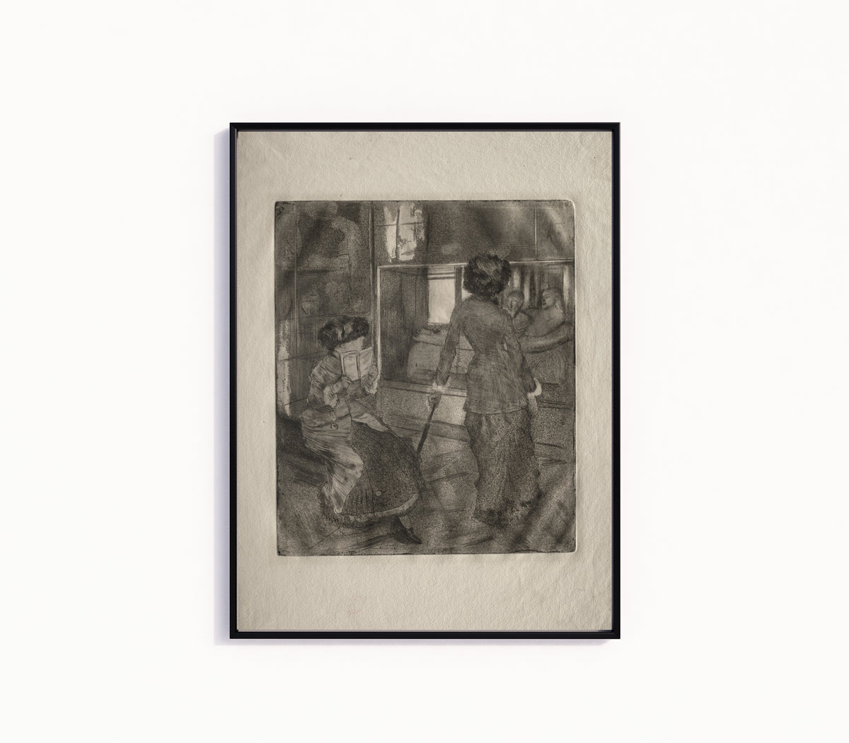 Framed art print of Mary Cassatt at the Louvre: The Etruscan Gallery by Edgar Degas, in a slim black frame on a plain white wall