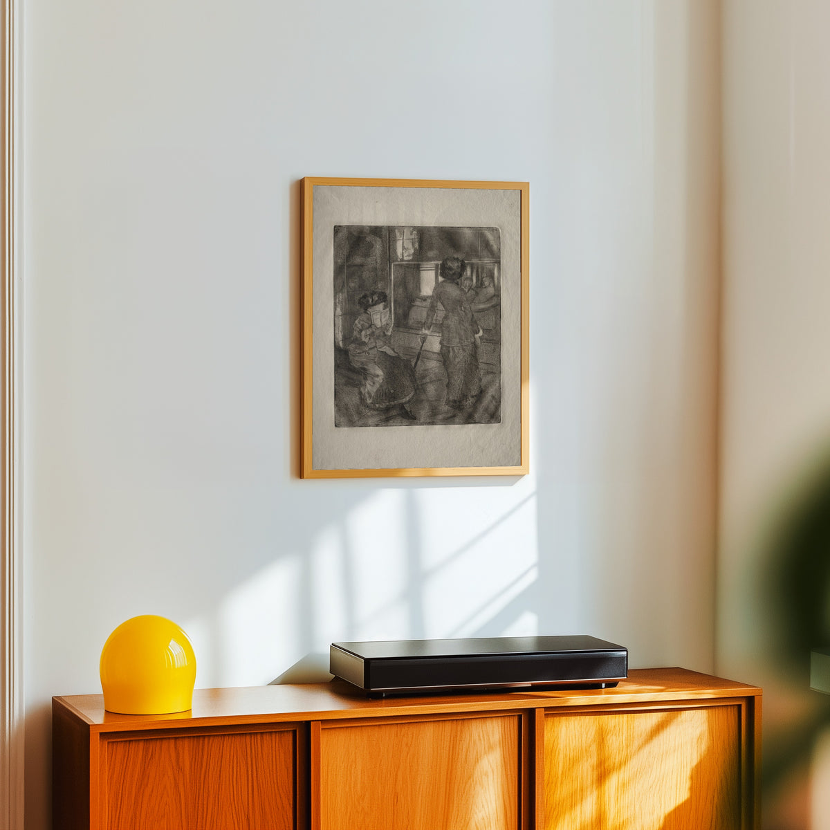 Framed art print of Mary Cassatt at the Louvre: The Etruscan Gallery by Edgar Degas, in a light wood frame on a white wall above an orange sideboard