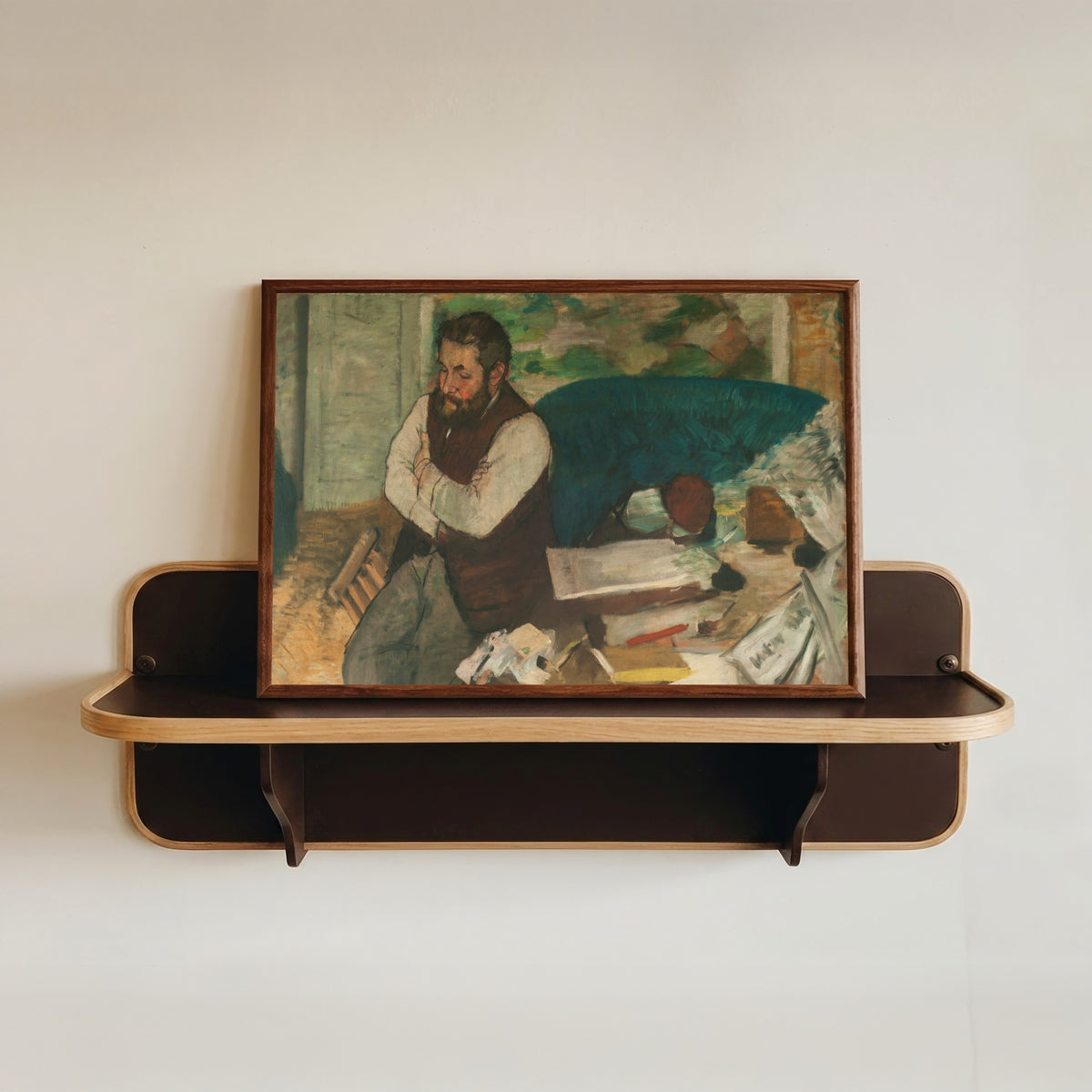 Framed art print of Portrait of Diego Martelli by Edgar Degas, in a dark wood frame resting on a wall shelf