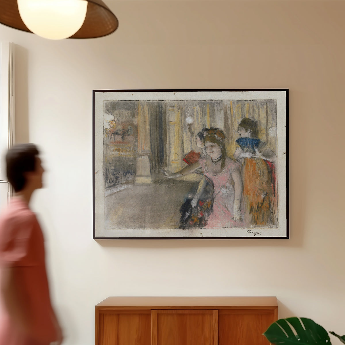 Framed art print of Singers on the Stage by Edgar Degas, in a slim black frame on a warm wall in a sunlit room