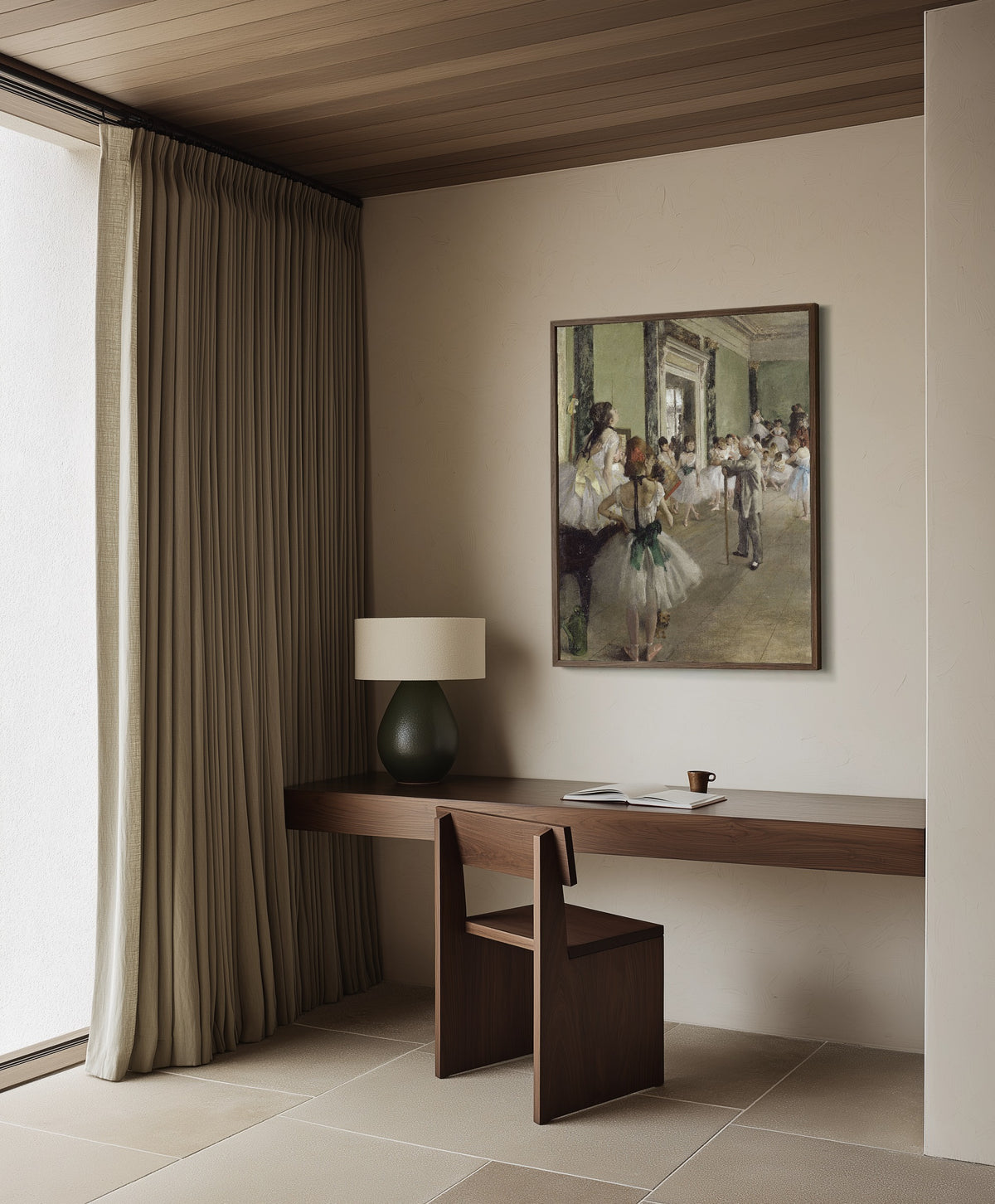 Framed art print of The Ballet Class by Edgar Degas, in a dark wood frame on a plaster wall above a walnut desk