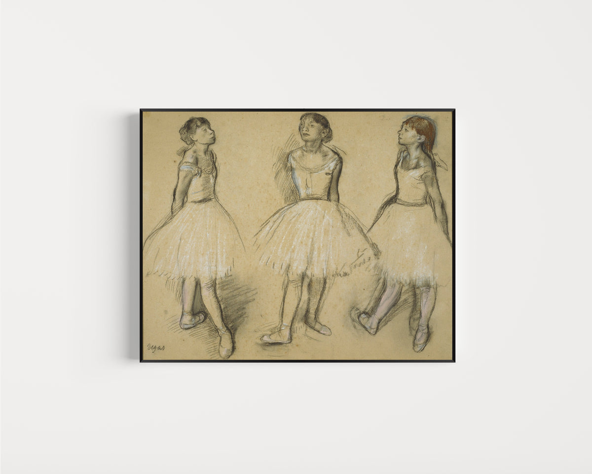 Framed art print of Three Studies of a Dancer in Fourth Position by Edgar Degas, in a slim black frame on a plain white wall