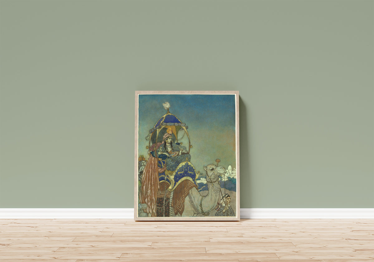 Framed art print of The Queen of Sheba by Edmund Dulac, in a light wood frame leaning on a sage green wall above a wooden floor