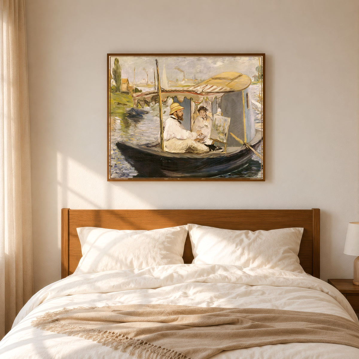 Framed art print of Claude Monet Painting in His Studio Boat by Édouard Manet, in a slim wood frame above a bed in a sunlit bedroom