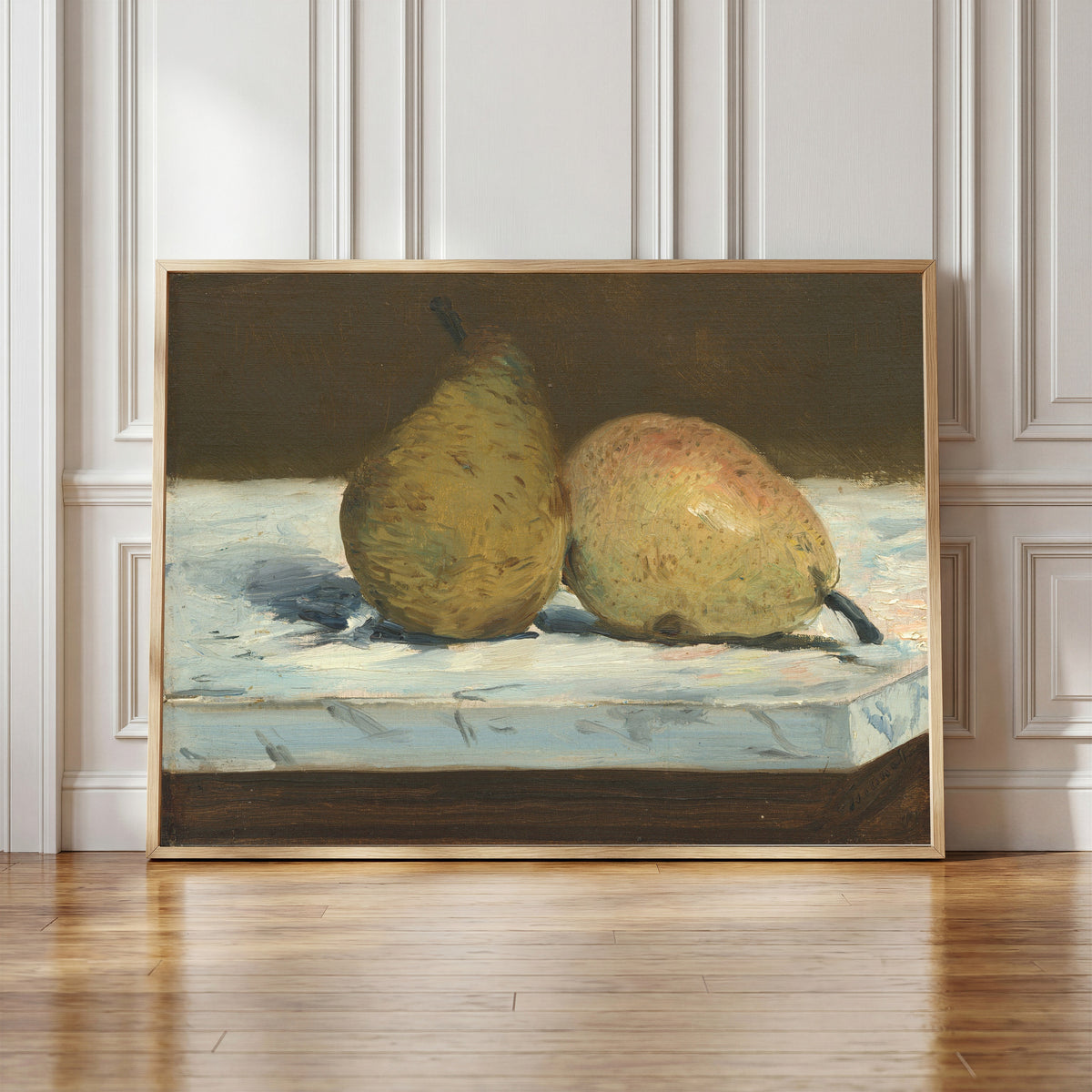 Framed art print of Pears by Édouard Manet, in a light wood frame leaning against a panelled white wall