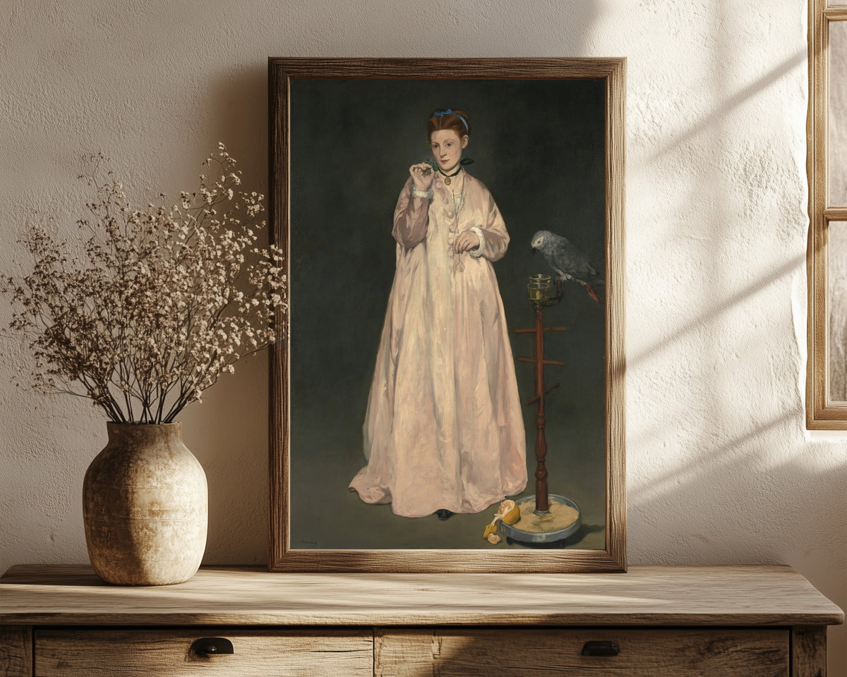 Framed art print of Young Lady in 1866 by Édouard Manet, in a dark wood frame leaning on a rustic console beside dried flowers