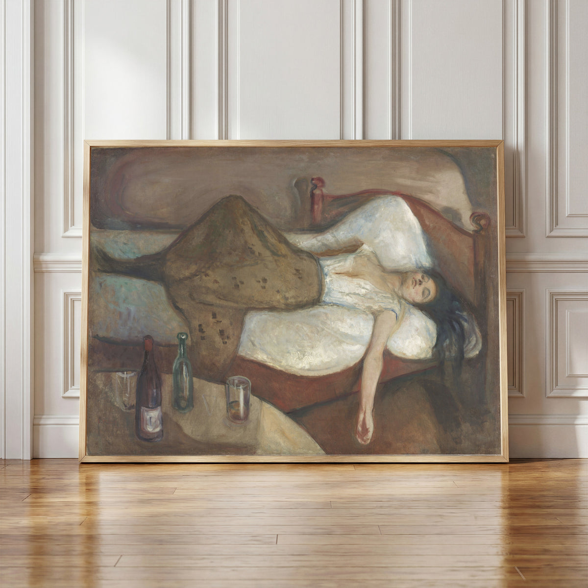Framed art print of The Day After by Edvard Munch, in a light wood frame leaning against a panelled white wall