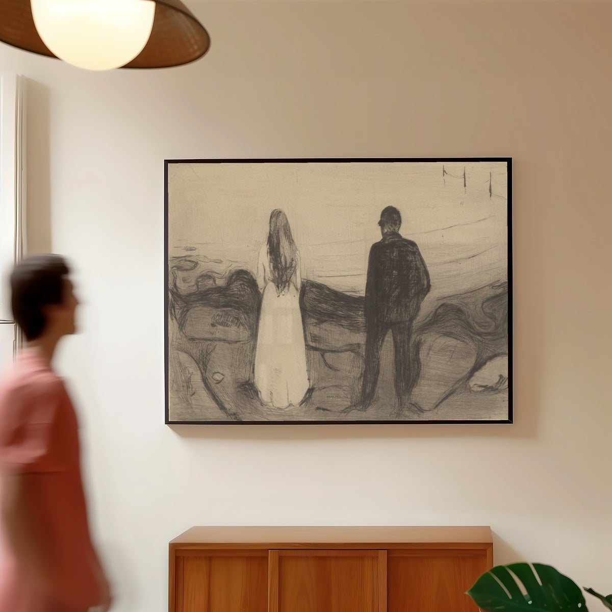 Framed art print of Two People (The Lonely Ones) by Edvard Munch, in a slim black frame on a warm wall in a sunlit room