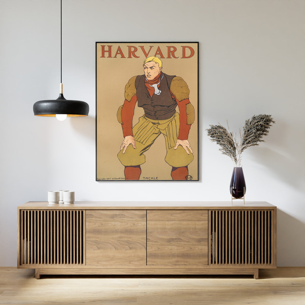 Harvard by Edward Penfield — framed above a slatted wood sideboard