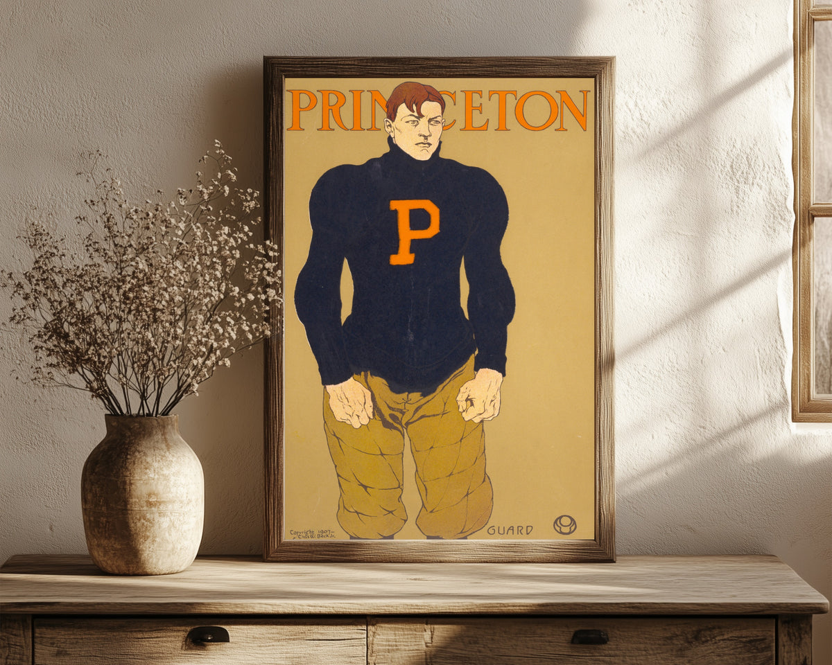 Framed art print of Princeton by Edward Penfield, in a dark wood frame leaning on a rustic console beside dried flowers