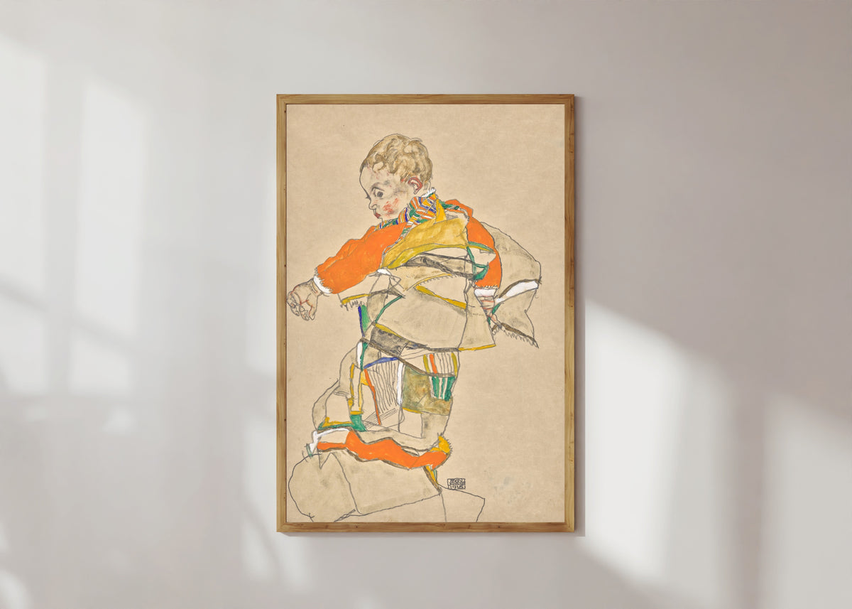 Framed art print of Portrait of a Child (Anton Peschka Jr.) by Egon Schiele, in a light wood frame on a sunlit white wall