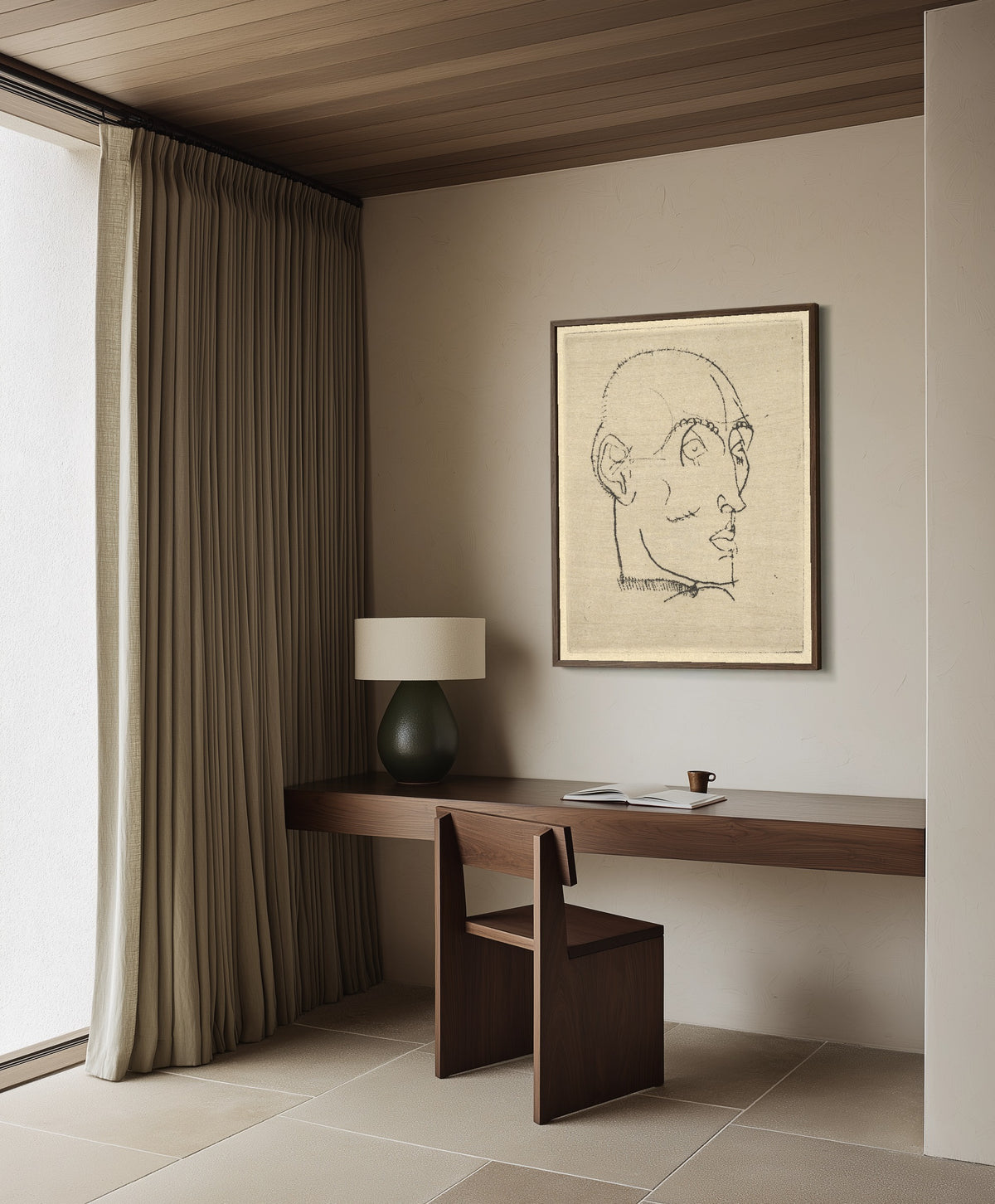 Framed art print of Portrait of a Man by Egon Schiele, in a dark wood frame on a plaster wall above a walnut desk