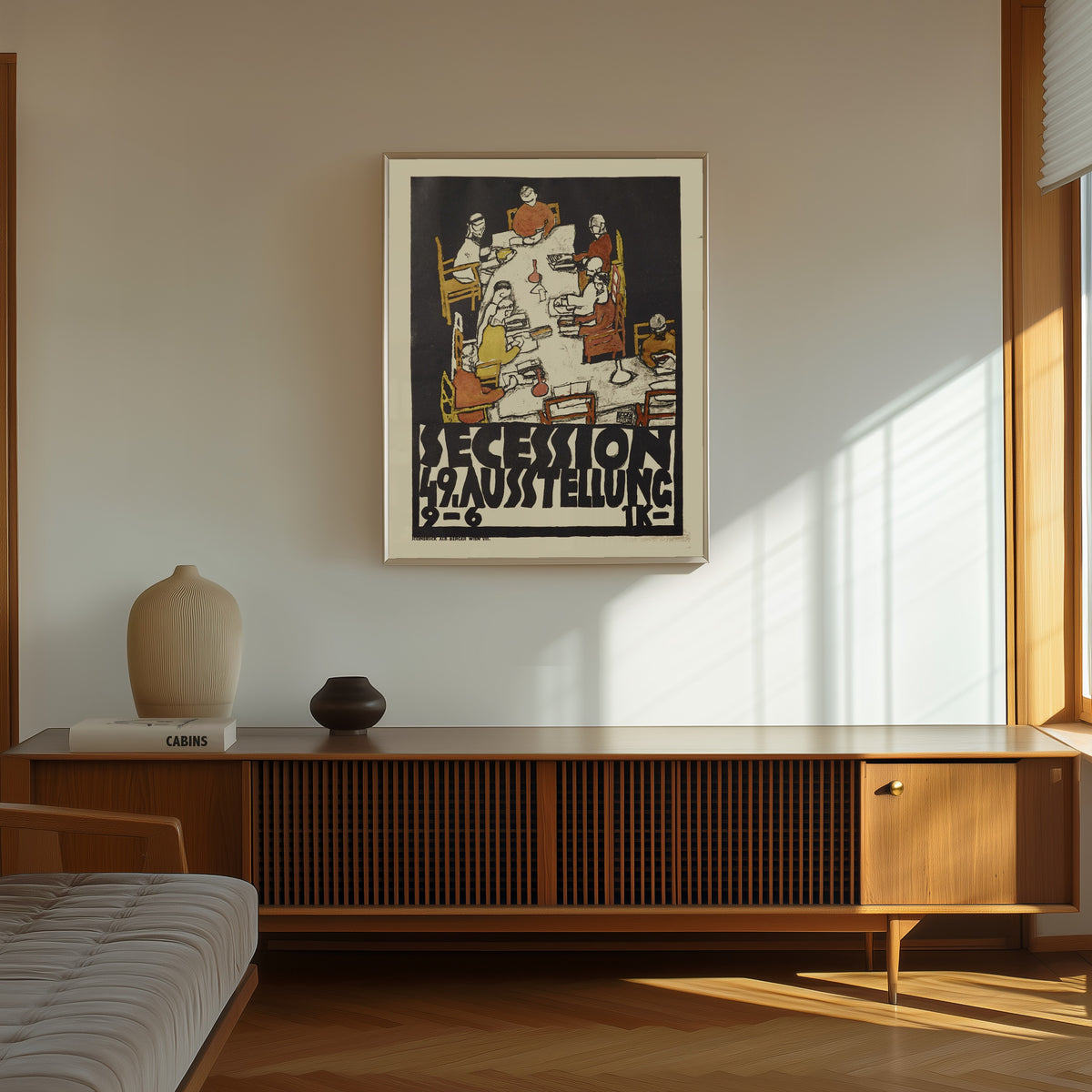 Framed art print of Vienna Secession 49th Exhibition Poster by Egon Schiele, in a thin light frame on a sunlit wall above a wooden sideboard