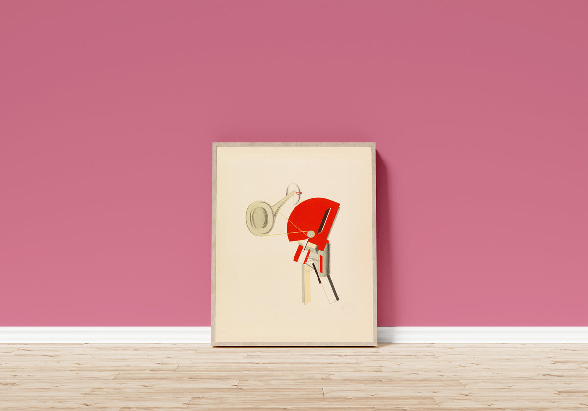 Framed art print of Figurines: The Announcer (Ansager) by El Lissitzky, in a light wood frame leaning on a pink wall above a wooden floor