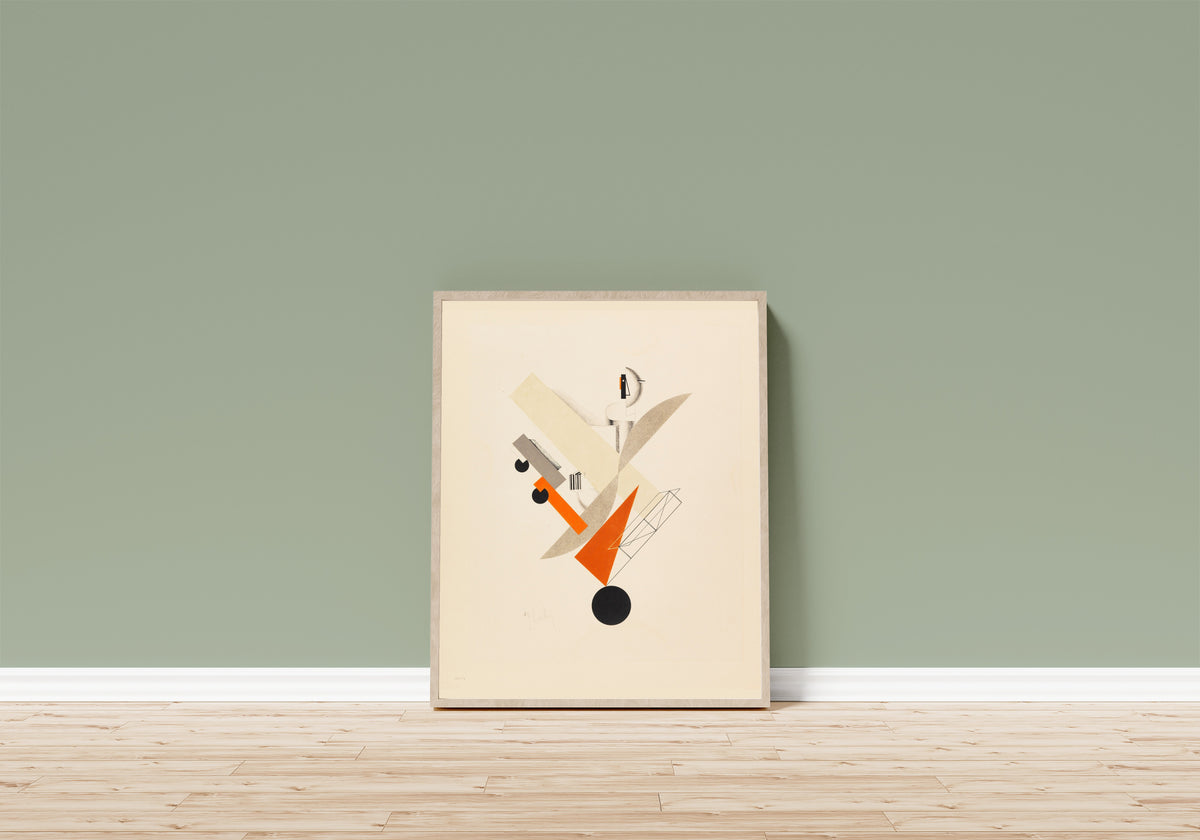 Framed art print of Figurines: The Globetrotter (in Time) by El Lissitzky, in a light wood frame leaning on a sage green wall above a wooden floor