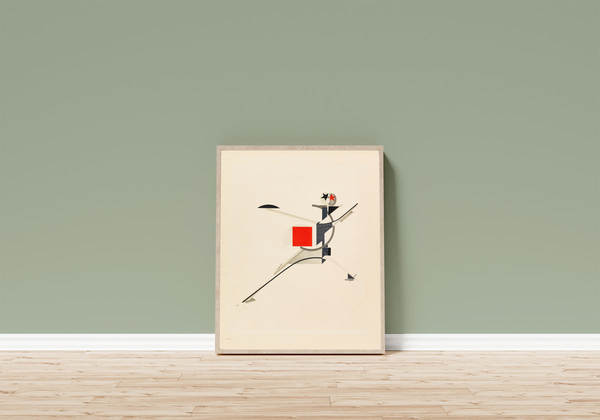 Framed art print of Figurines: The New Man (Neuer) by El Lissitzky, in a light wood frame leaning on a sage green wall above a wooden floor