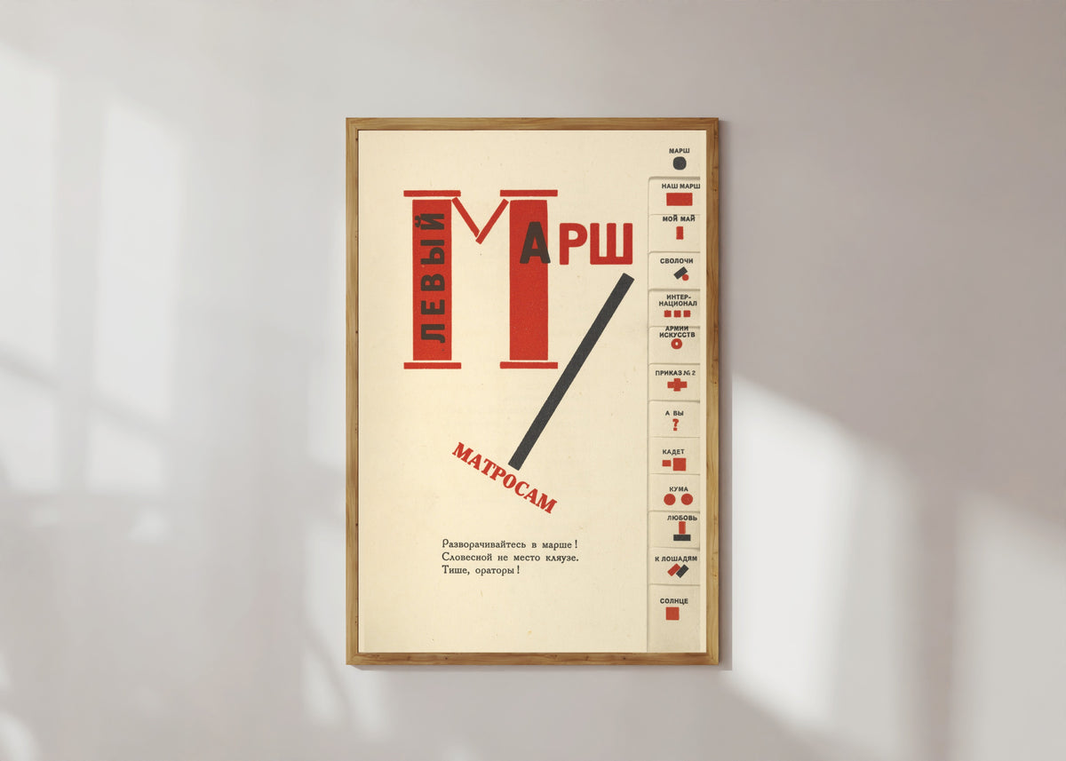 Framed art print of For the Voice: Left March (Title Page with Index Tabs) by El Lissitzky, in a light wood frame on a sunlit white wall