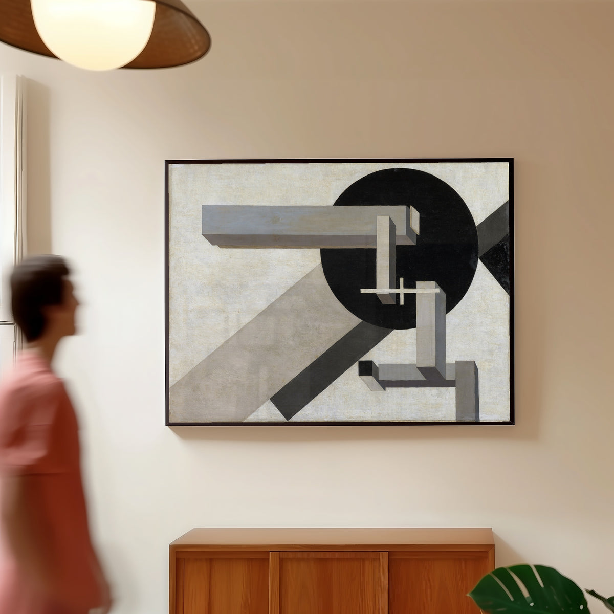 Framed art print of Proun 1D by El Lissitzky, in a slim black frame on a warm wall in a sunlit room