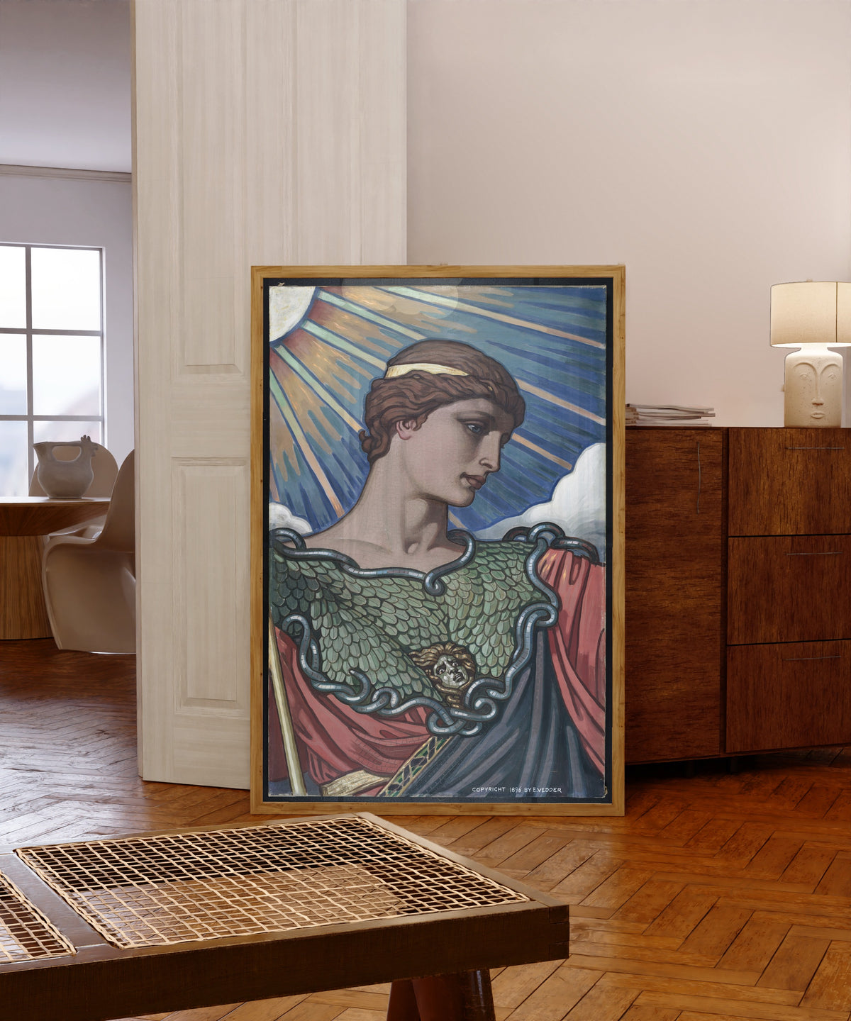Framed art print of Head of Minerva (1896) by Elihu Vedder, in a light wood frame leaning in a warm room with a parquet floor