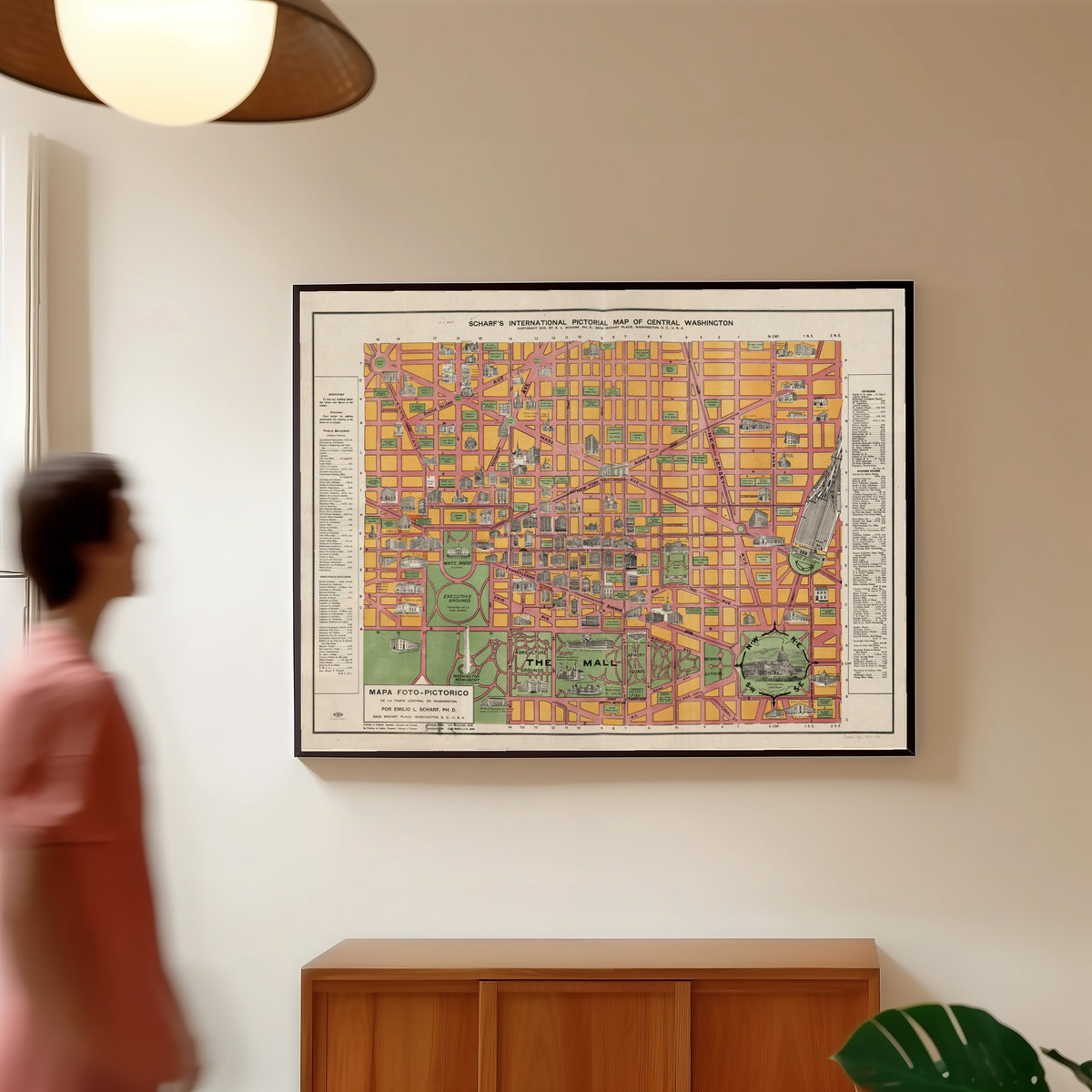 Framed art print of Scharf's International Pictorial Map of Central Washington by Emilio L. Scharf, in a slim black frame on a warm wall in a sunlit room