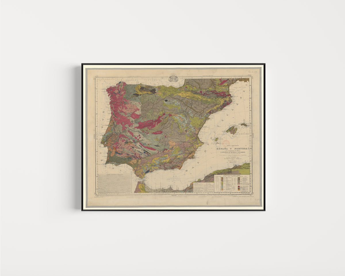 Framed art print of Mapa geológico de España y Portugal by Federico de Botella y de Hornos, in a slim black frame on a plain white wall