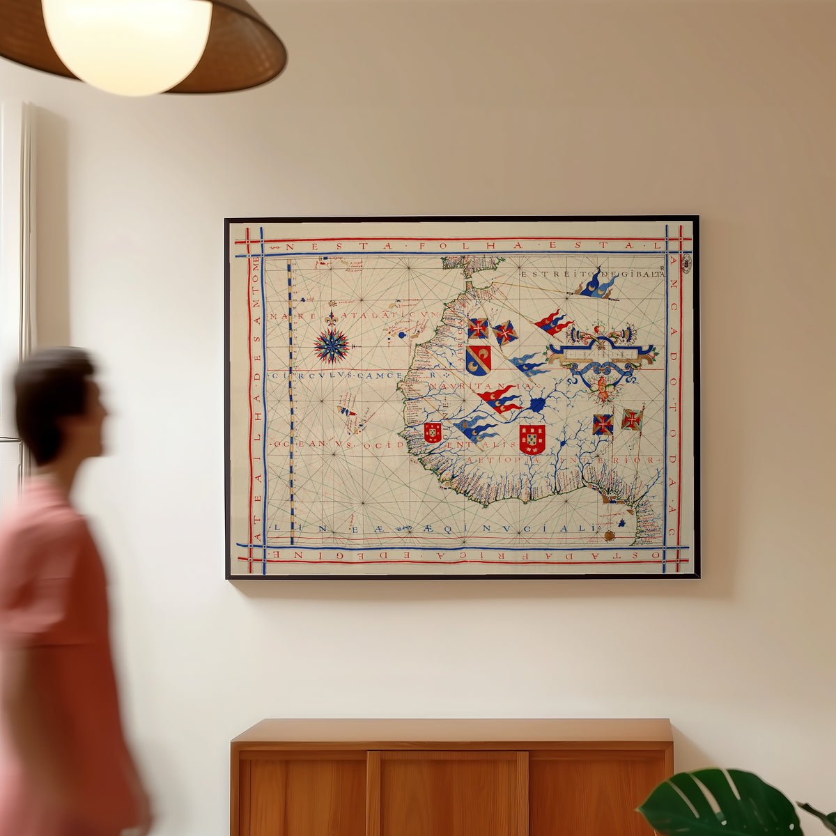 Framed art print of Nautical Chart of West Africa (Vaz Dourado Atlas) by Fernão Vaz Dourado, in a slim black frame on a warm wall in a sunlit room