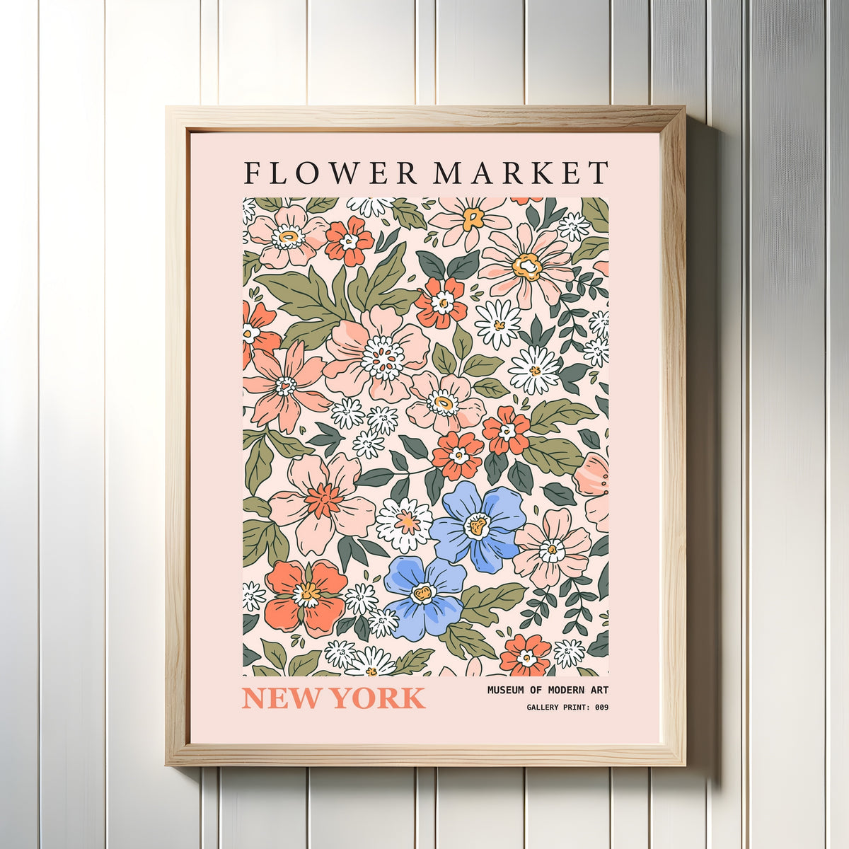Framed art print of New York by Original, in a light wood frame on a white panelled wall
